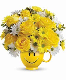 Mug filled with fresh cut yellow flowers 